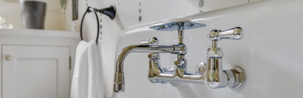 Vintage style chrome faucet in remodeled bathroom. 