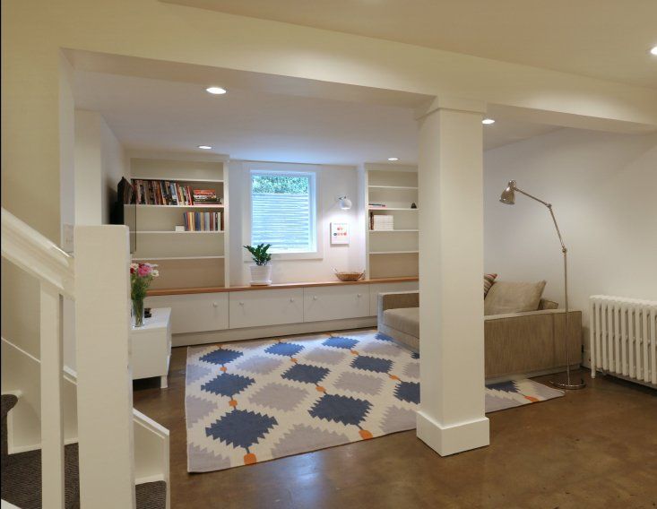 A living room with a rug and a couch
