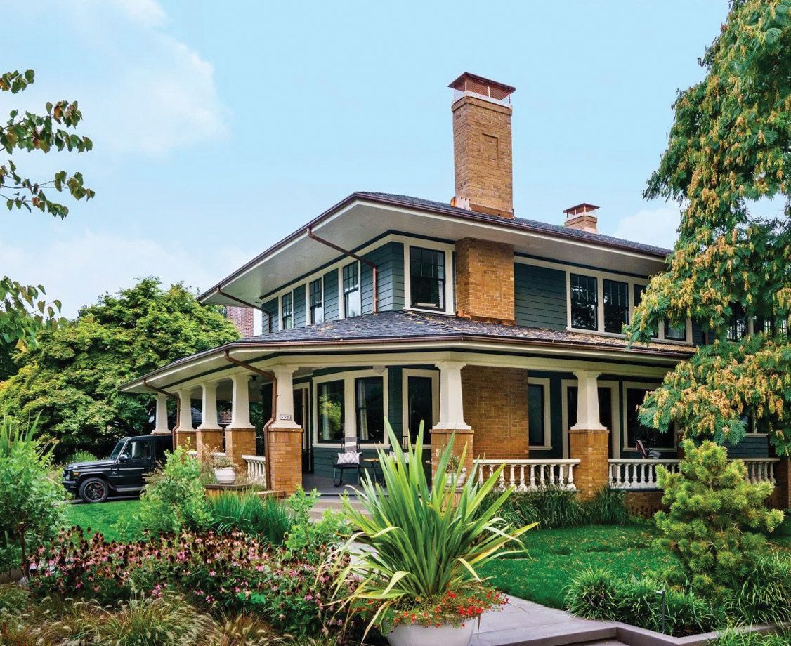 A large brick house with a car parked in front of it