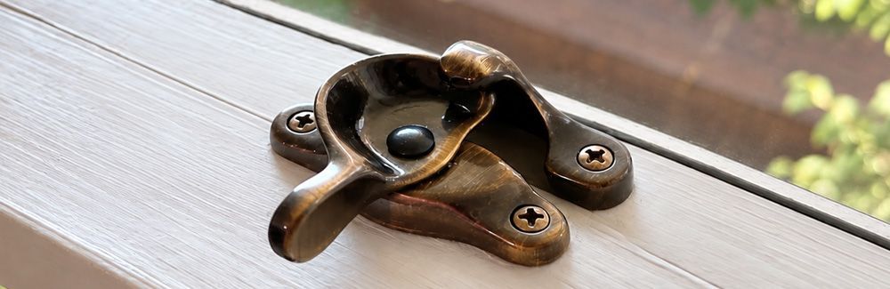 Window sash lock with lacquered antique brass finish.