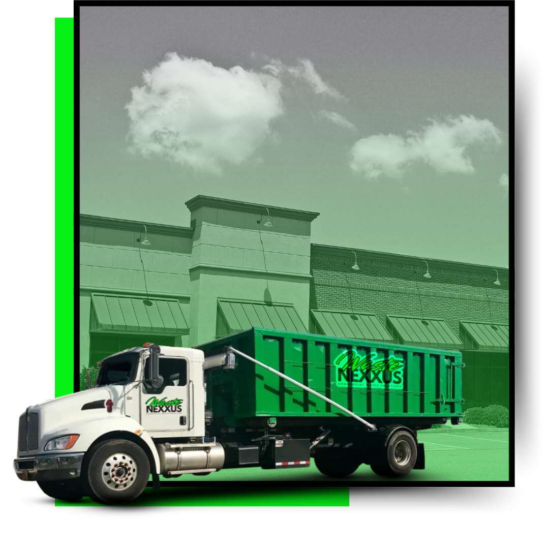 A dumpster truck with a commercial building in the background