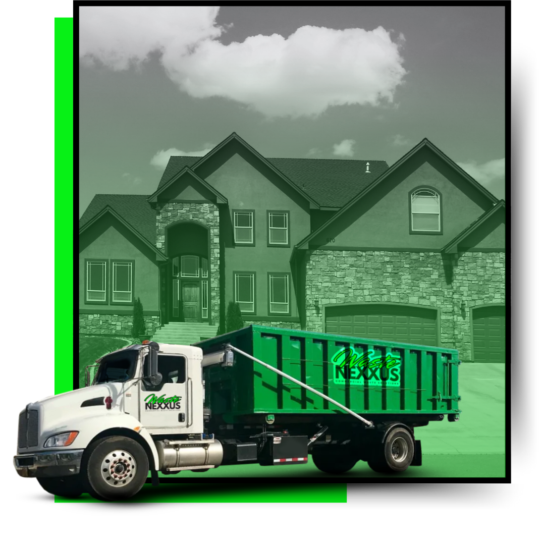 A dumpster truck with a commercial building in the background