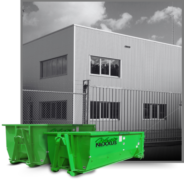 Dumpsters in front of an industrial building