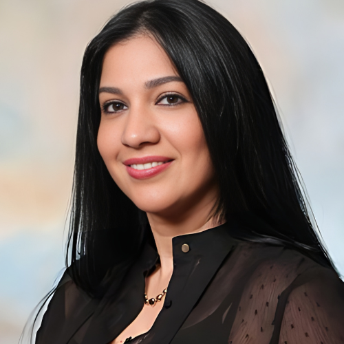 A woman with long black hair is smiling for the camera