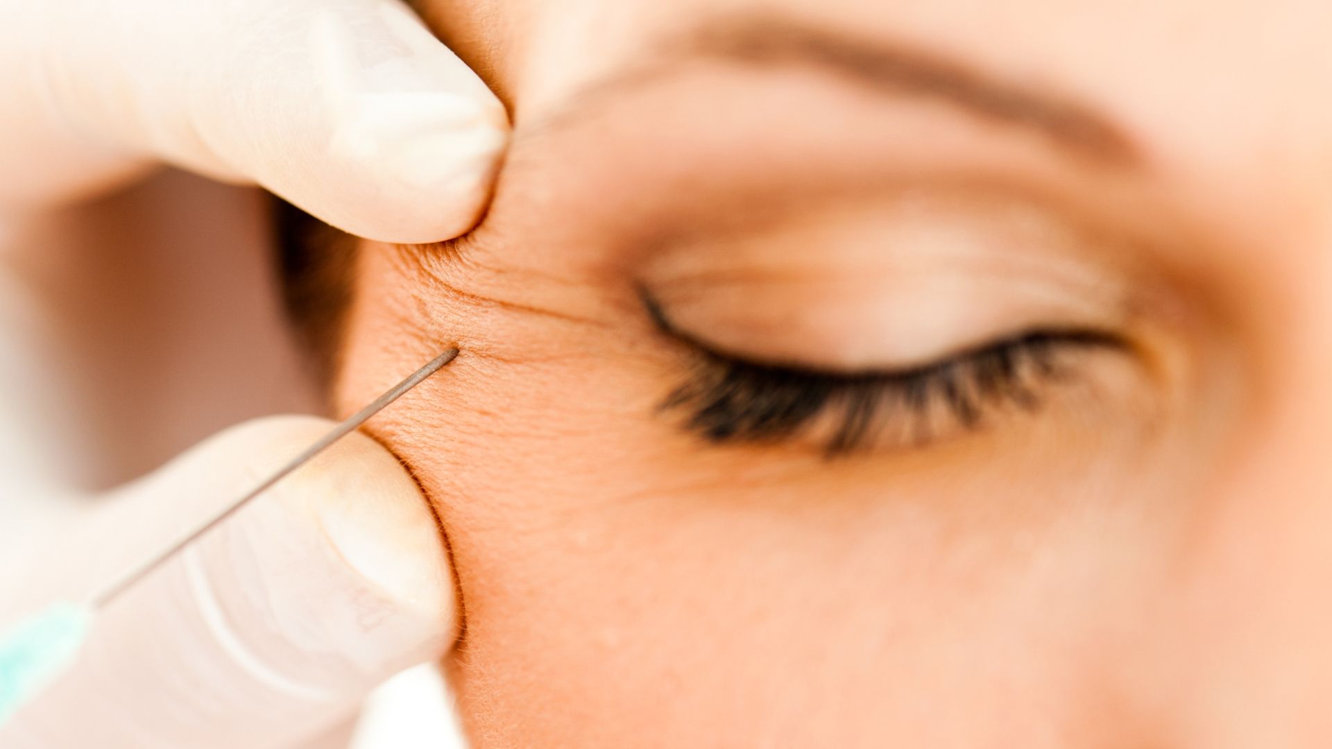 A woman is getting an injection in her eye.