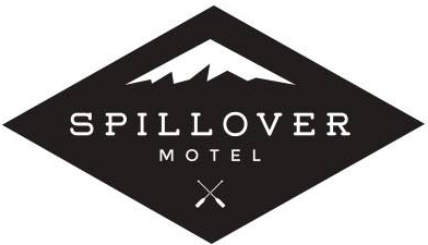 Spillover Motel logo in a black diamond with white mountain graphic and crossed lines below