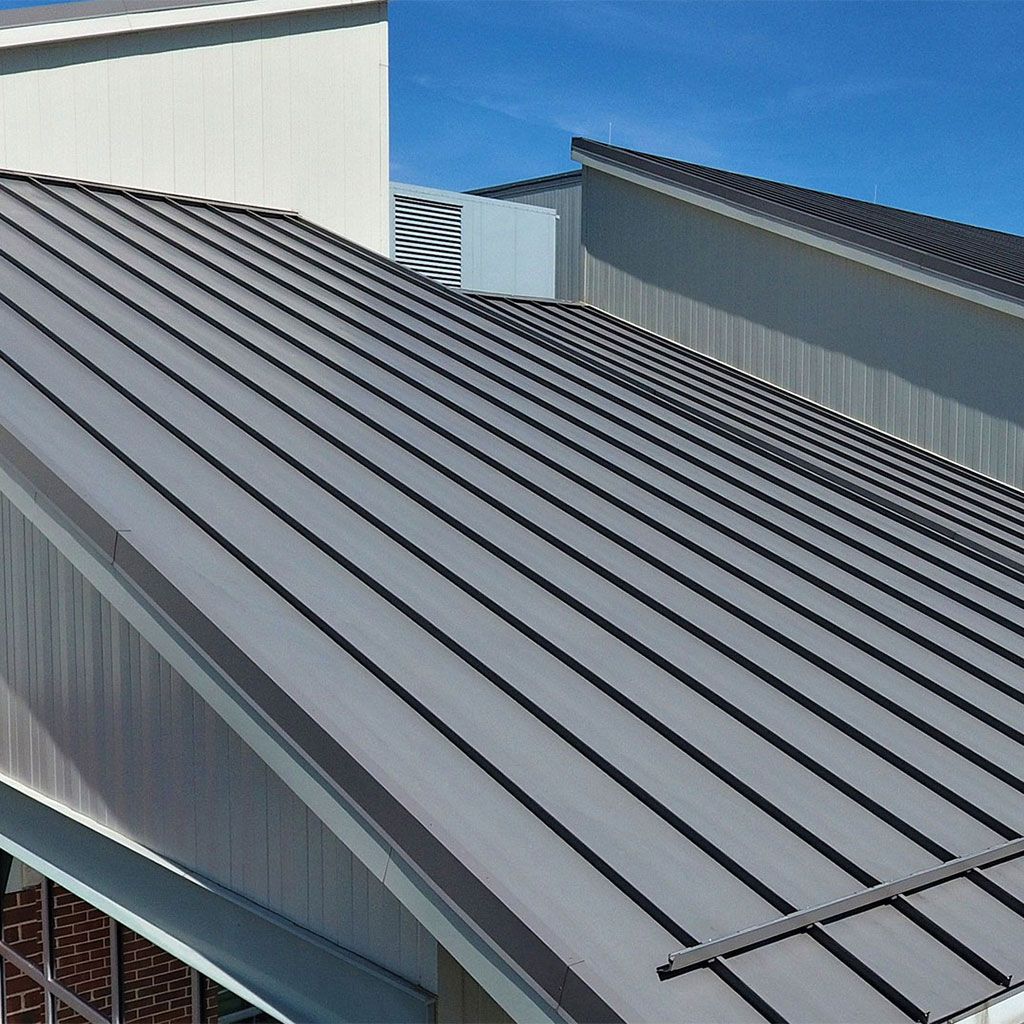 Close-up of an orange corrugated metal roof with blue sky in the corner