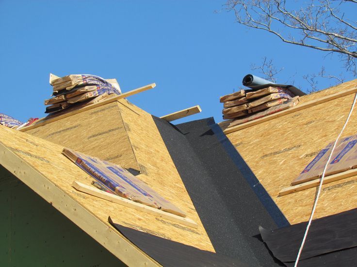 Roof shingles with two small black vents on a sloped rooftop