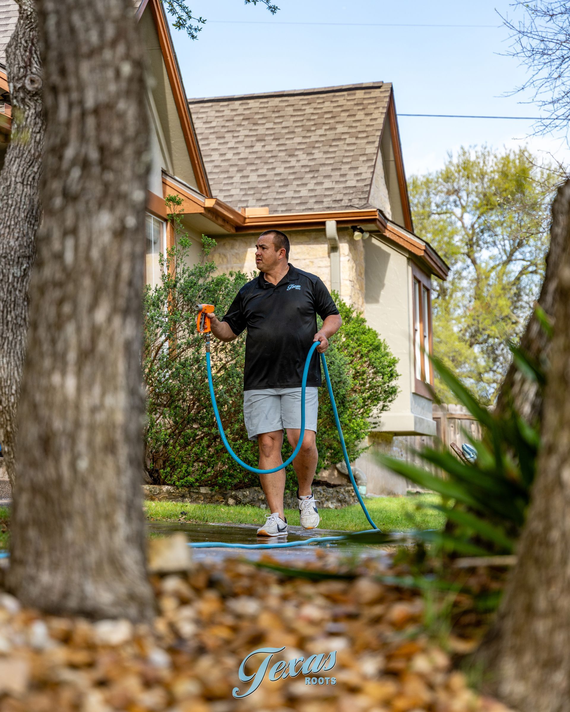	Exterior cleaning technician performing house wash in Central Texas