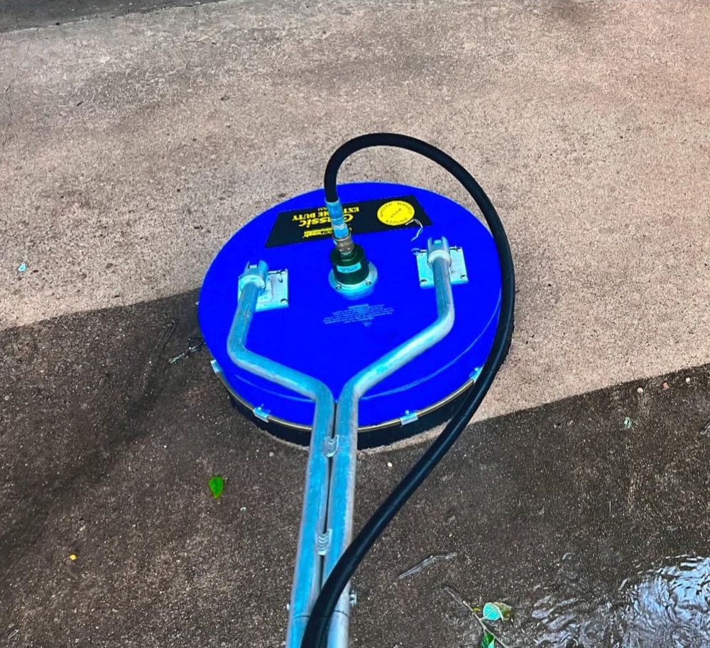 Blue Surface Cleaner Sitting on Concrete Surface | Buda, TX | Texas Roots Property Care
