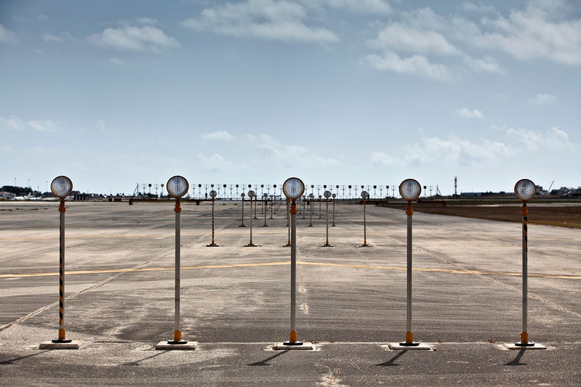 A row of traffic lights positioned along an airport runway
