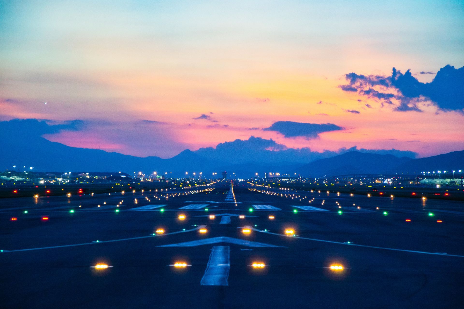 Airfield ground lighting on a runway, sunrise time at an airport. Airfield ground lighting on a runway, sunrise time at an airport.