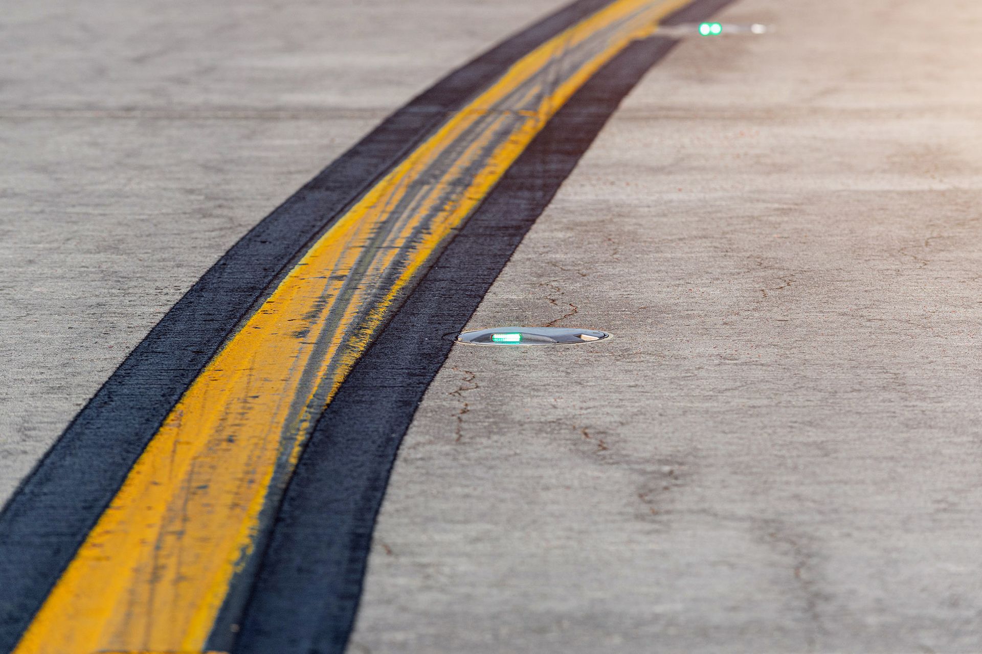 Airfield ground lighting on a runway, sunrise time at an airport. Airfield ground lighting on a runway, sunrise time at an airport.