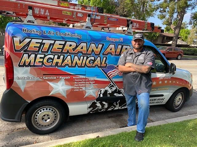 Man in uniform stands by a van with