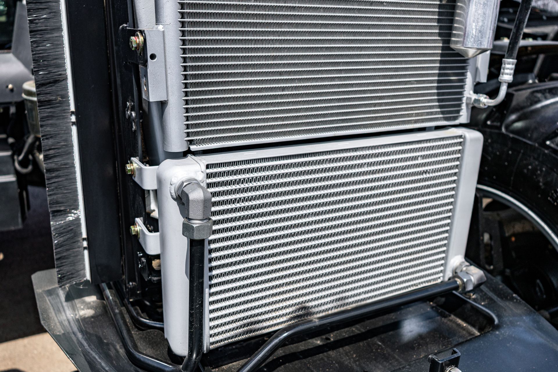 Close-up of a truck radiator and intercooler grille assembly in a engine bay