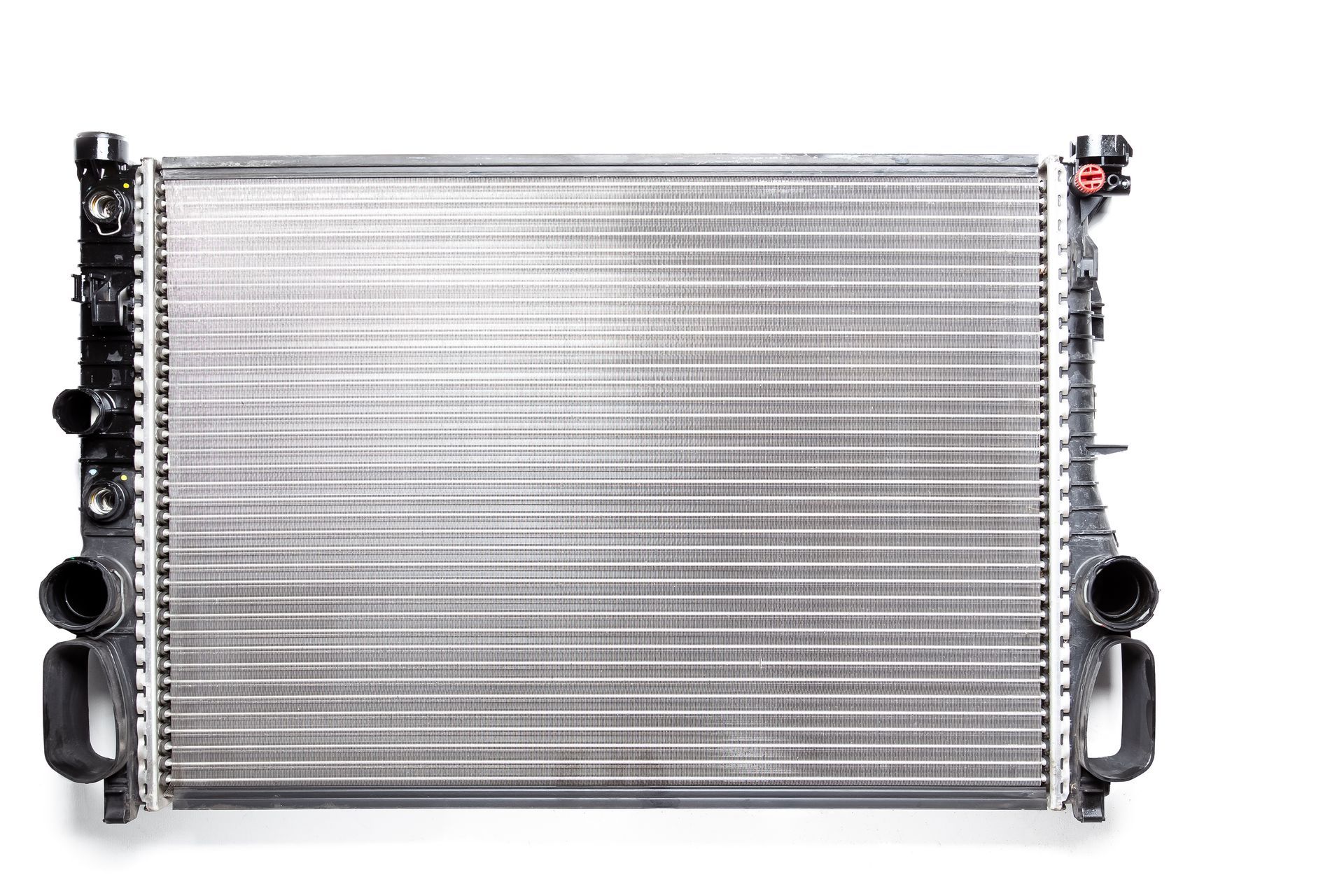 Silver radiator with black side tanks and inlet/outlet ports, isolated on white background