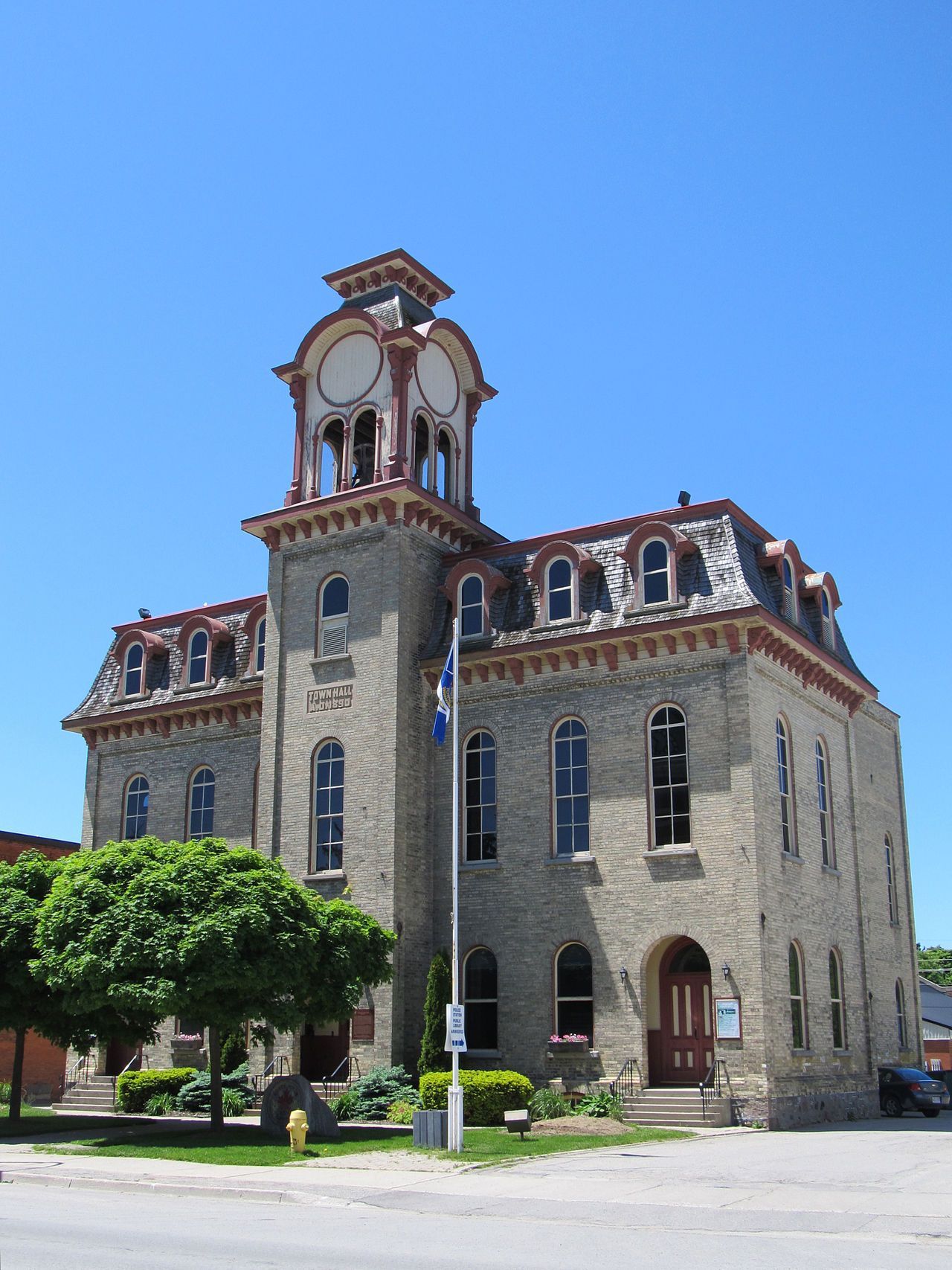 Historic stone courthouse with a clock tower under a clear blue sky