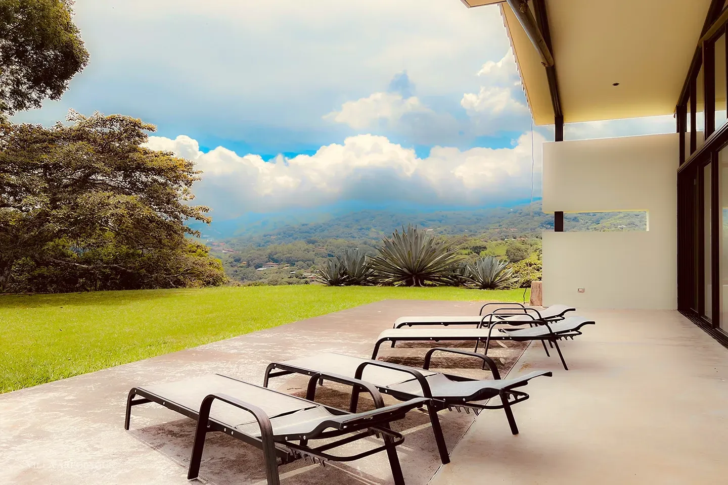 photograph of outdoor patio, reclines and spectacular view