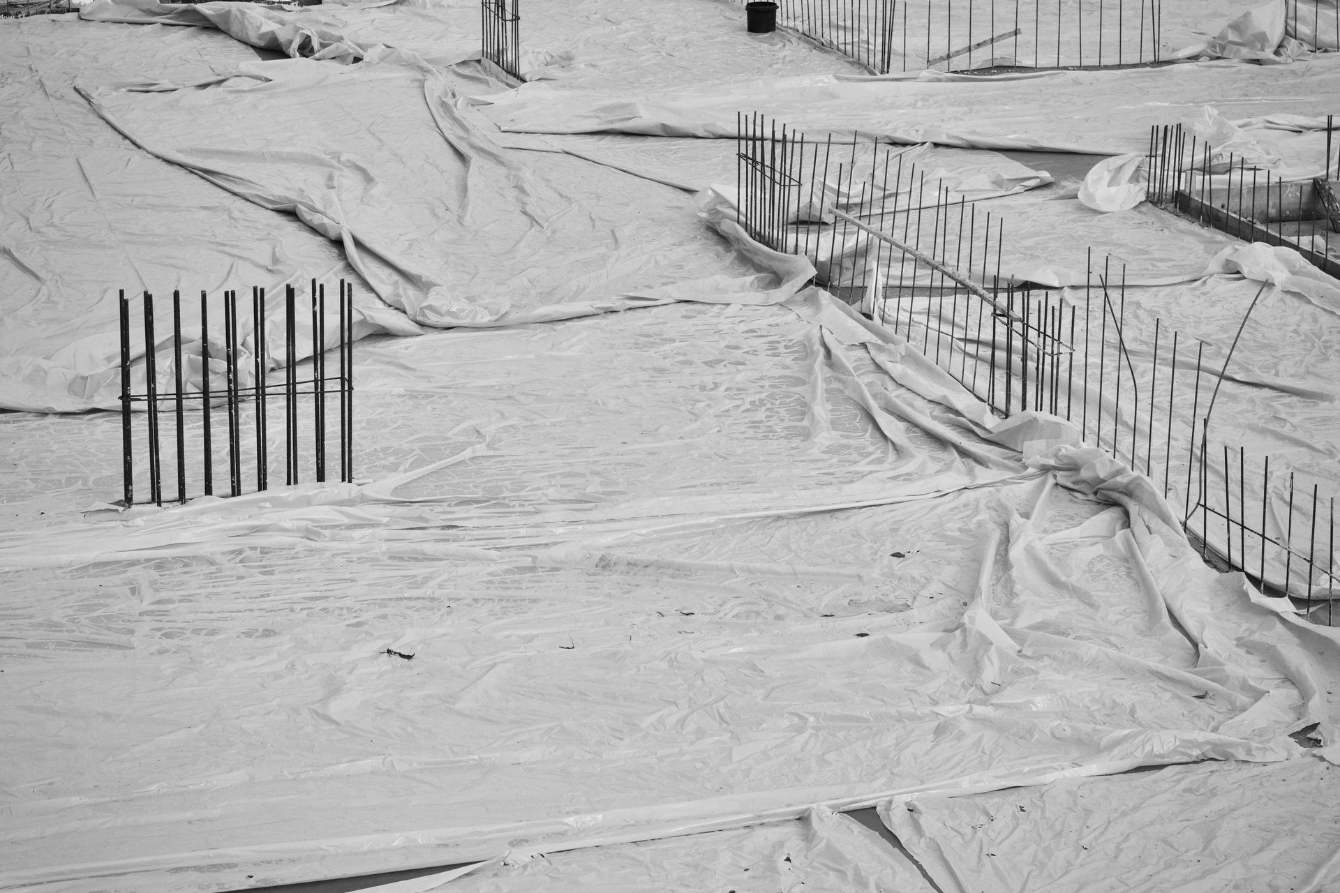 Snow-covered street with barricades and footprints in a winter scene