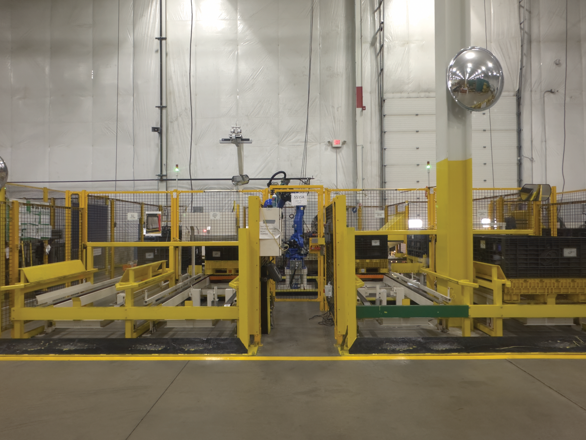 A warehouse with a lot of machinery and a mirror on the wall.