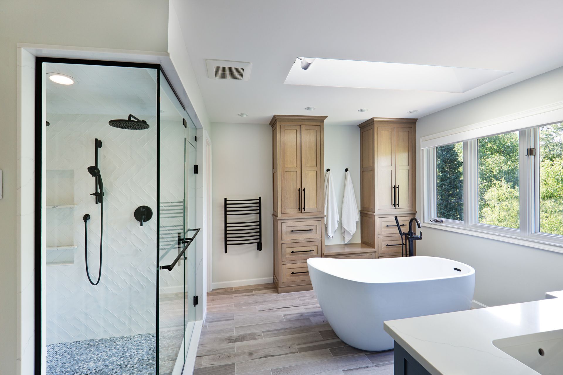 A bathroom with a tub, shower, sink and window - Douglassville, PA - Integrity Home Remodel