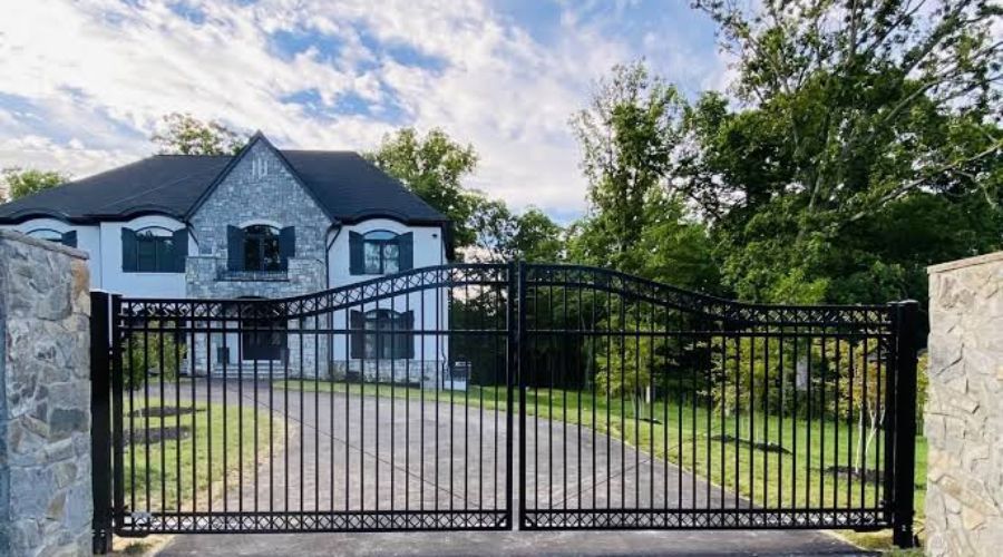 Secure black metal double driveway gate for a residential estate.
