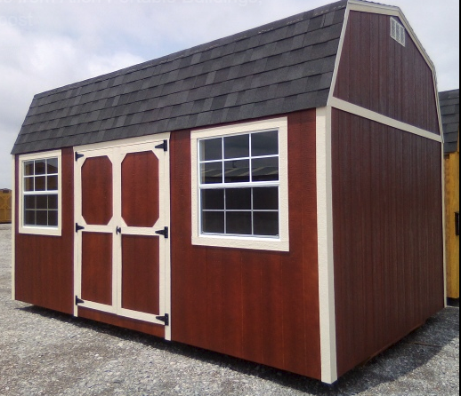 Red barn-style shed with white trim, dark roof, double doors, and two windows.