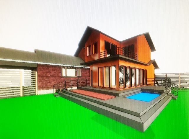 A two-story modern house with an orange exterior, a brick wing, a deck, and a small pool set against a bright green lawn.