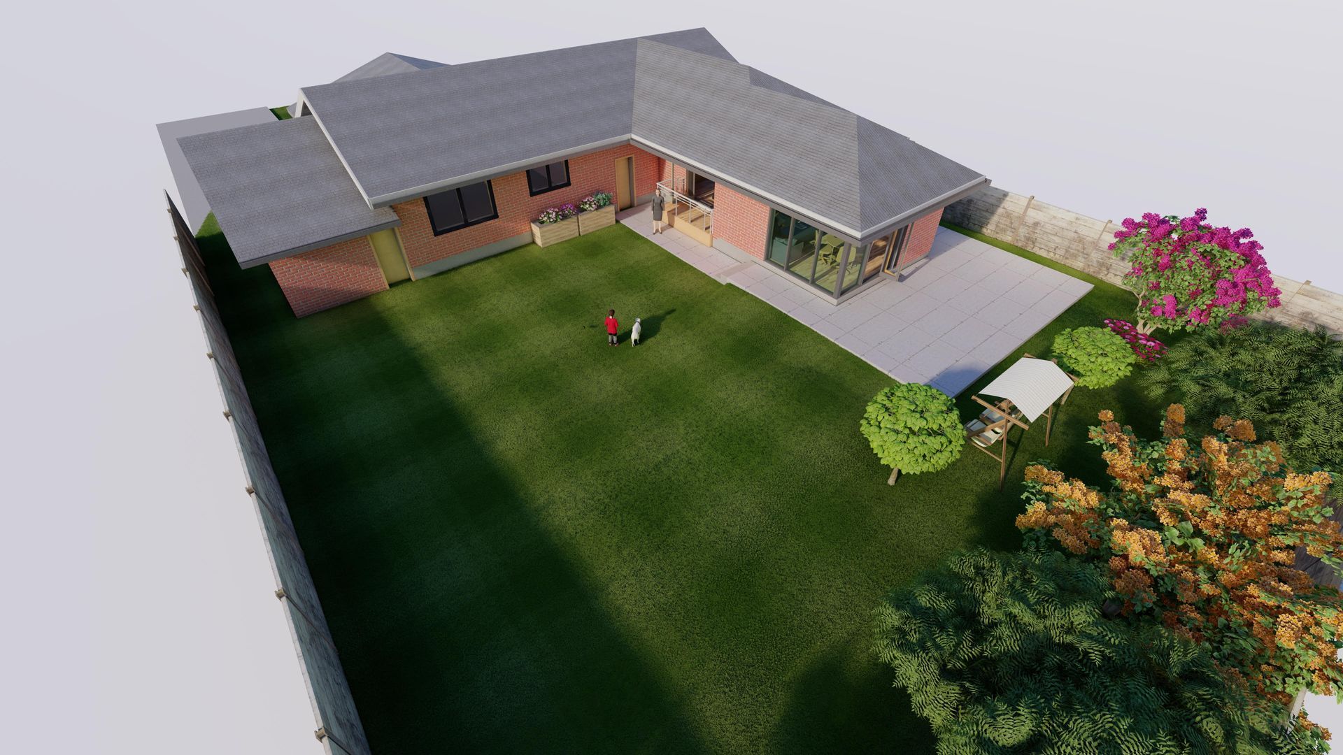 Aerial view of a salmon-colored L-shaped house with a grey roof, patio, green lawn, and garden with trees.