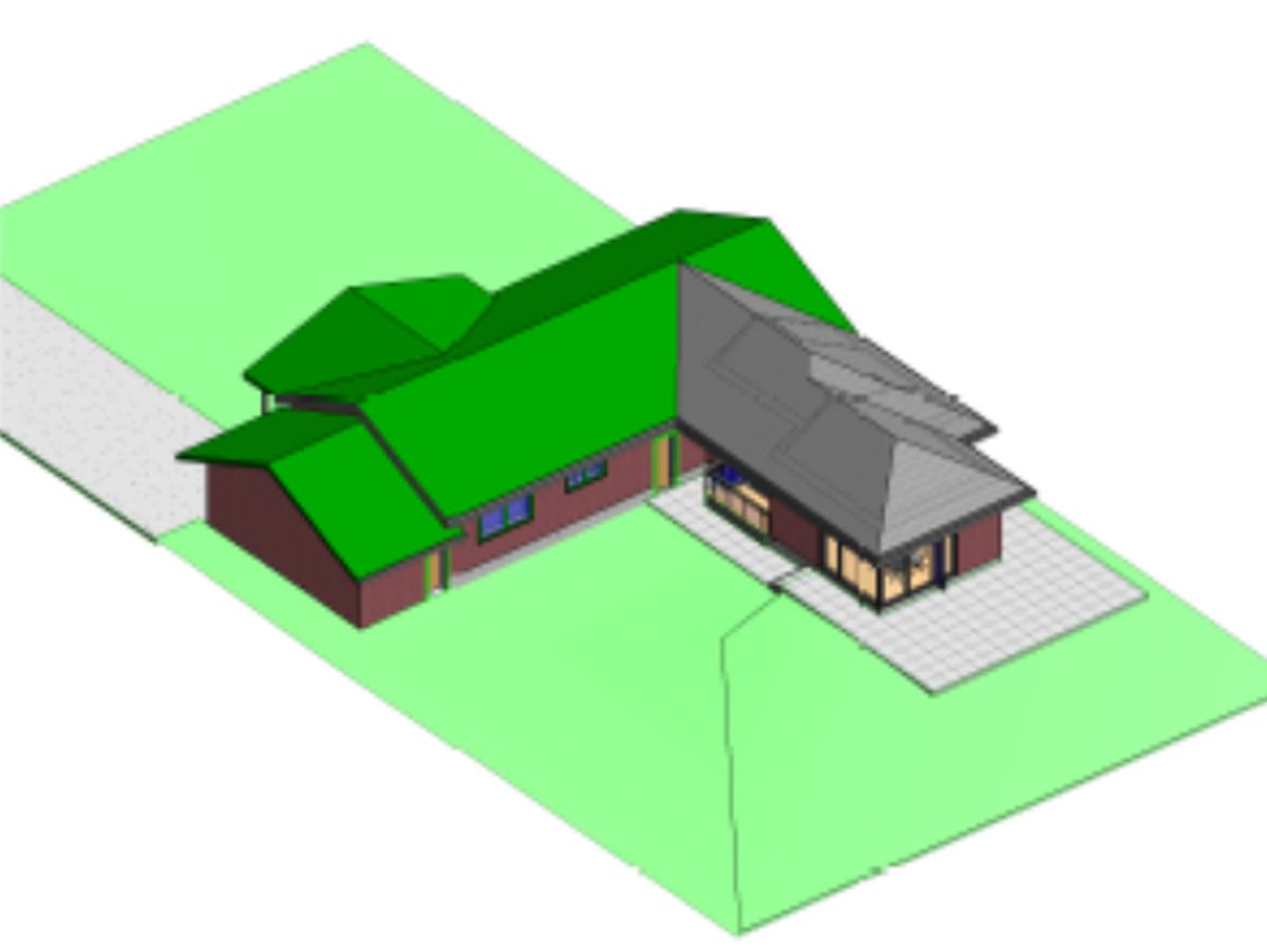 A 3D model of an L-shaped house with green and gray roofs, situated on a grassy plot with a small paved patio.