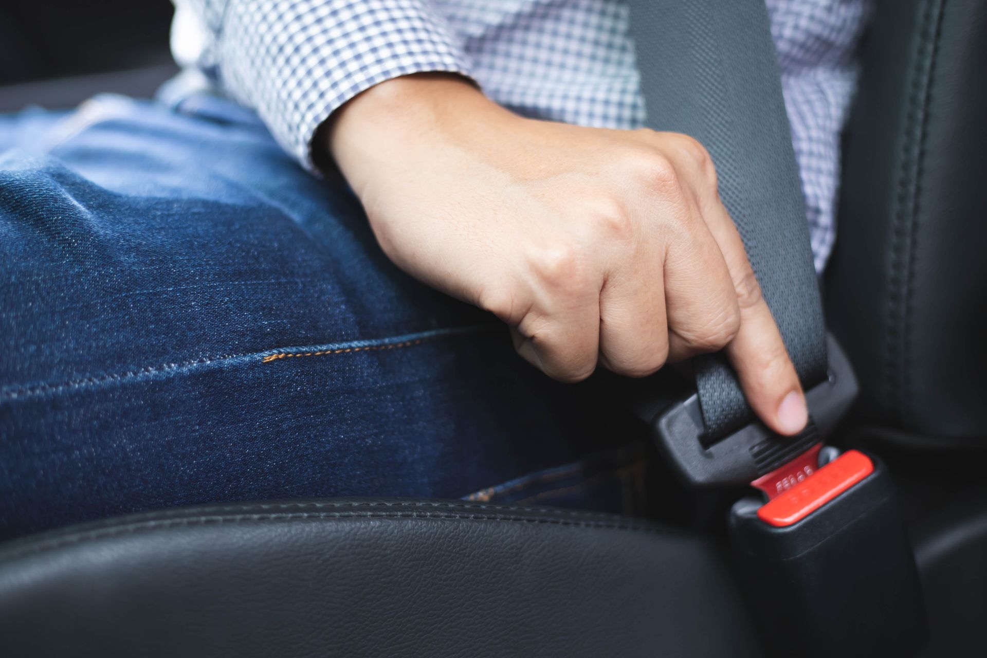 Close up image.A man of hand fastening seat belt for safety driving. Transportation concept.