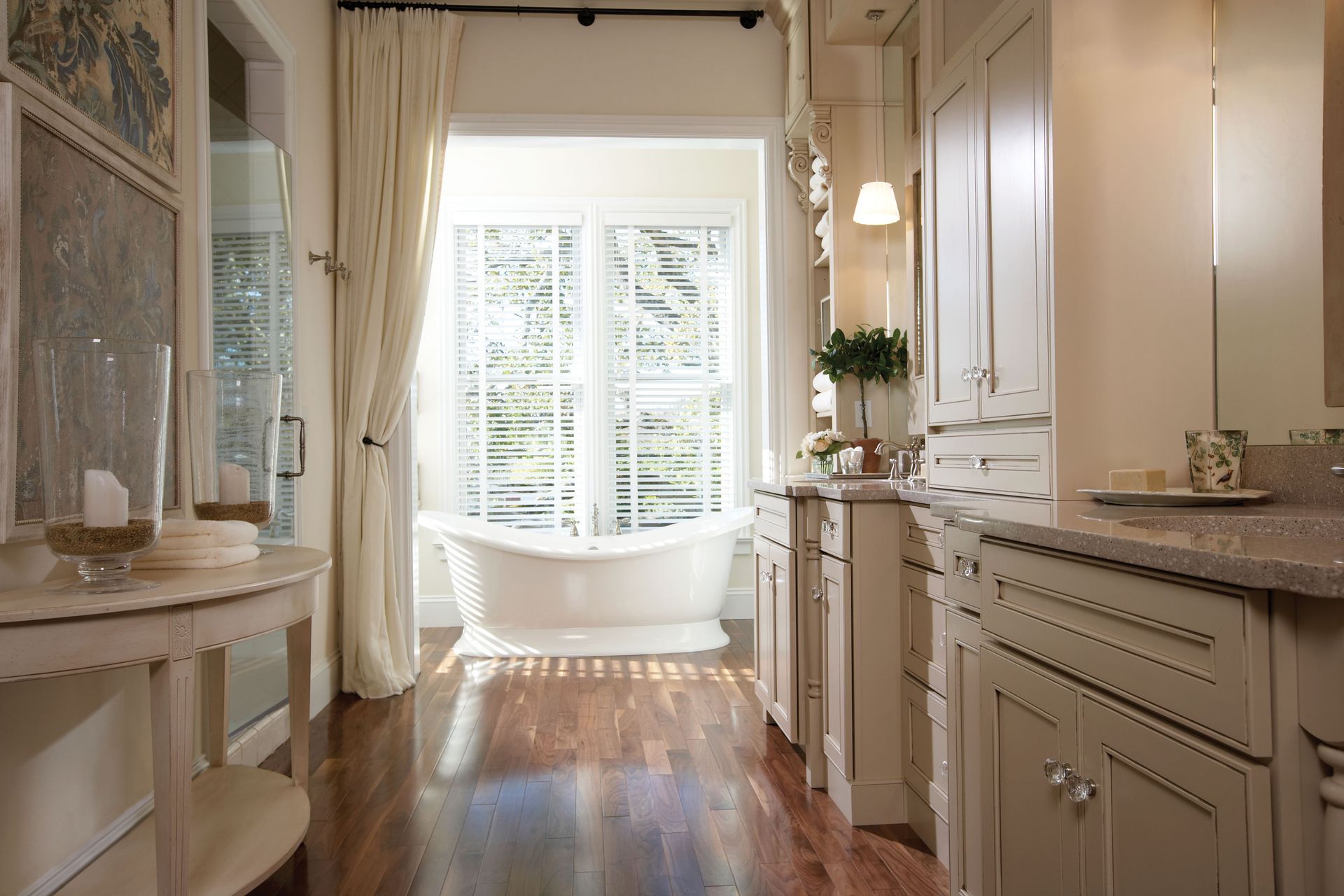Elegant bathroom with a freestanding tub, double vanity, and large mirror in a bright, modern interior
