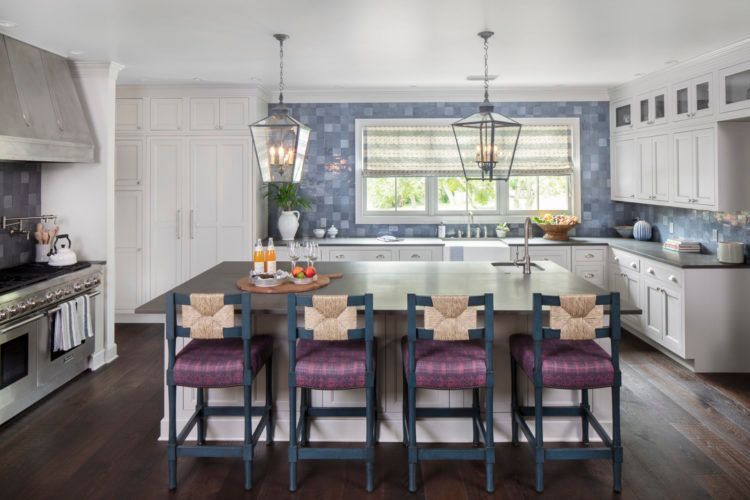 Bright modern kitchen with a large island, hanging lanterns, and blue-gray accents