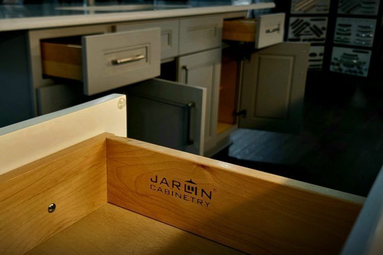 Open drawer in an office with wooden interior and filing cabinets in the background
