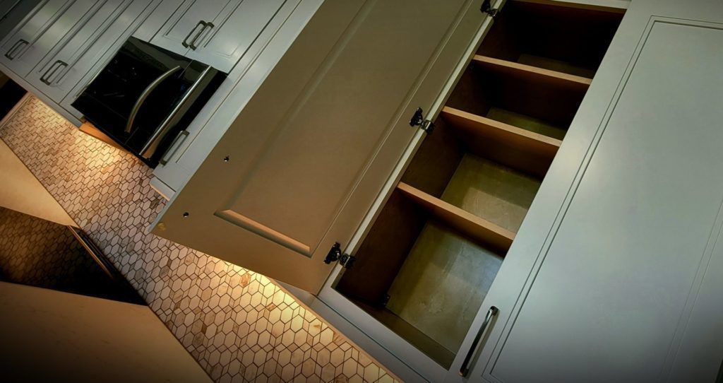 Indoor staircase with carpeted steps and closed white doors under warm lighting