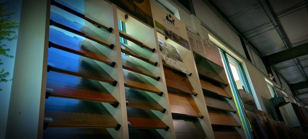Interior of a warehouse with tall wooden shelves holding colorful slanted panels under industrial lighting