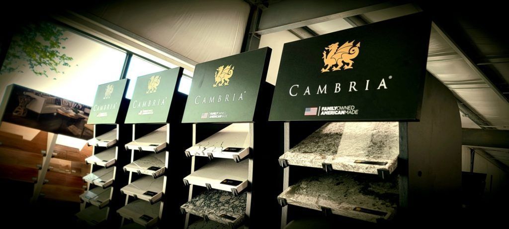 Retail display of Cambria countertop sample boards on shelves in a showroom