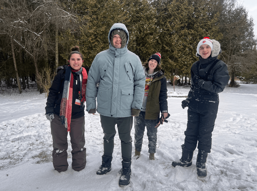 A group of people are standing in the snow.