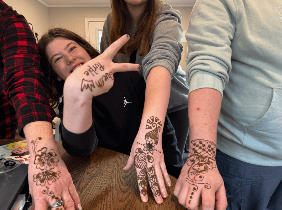 A group of people with henna tattoos on their hands