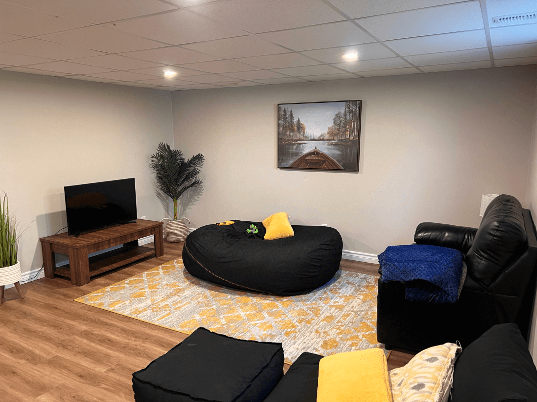 A lounge area with some seating and a TV