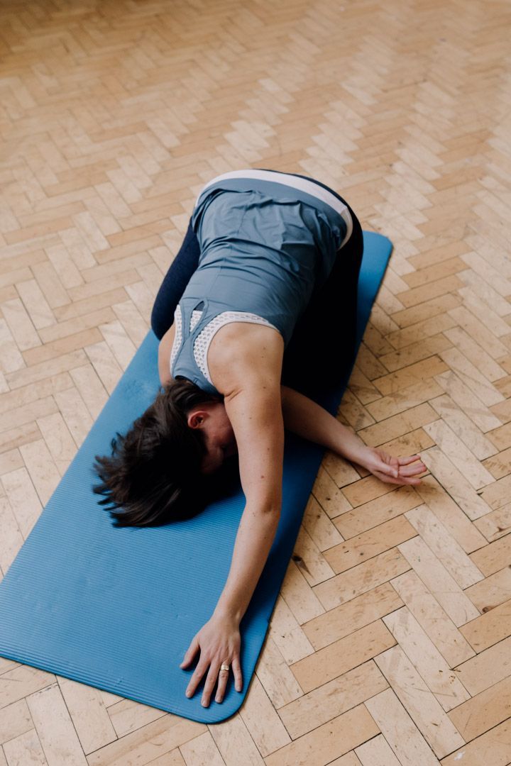 photo of instructor on  knees and stretching one arm under the body