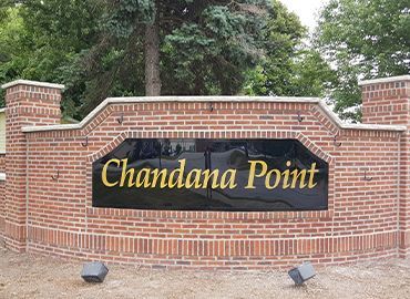A brick wall with a sign that says chandana point