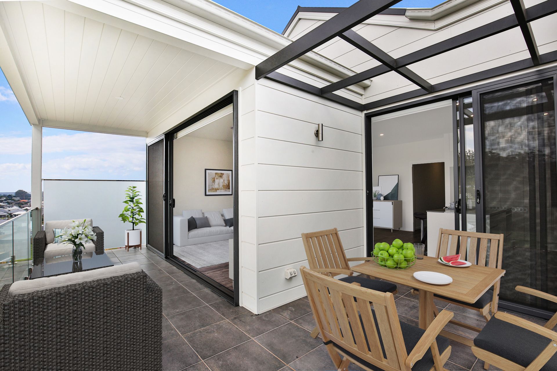Outdoor patio with table, chairs, and sliding glass doors to a bedroom.
