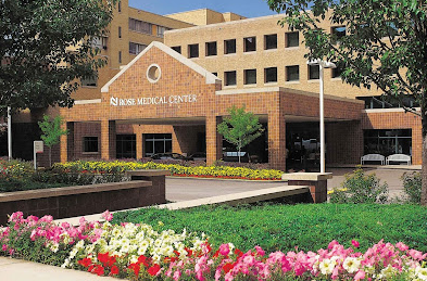 Rose Medical Center exterior with brick facade, arched entryway, and landscaping.