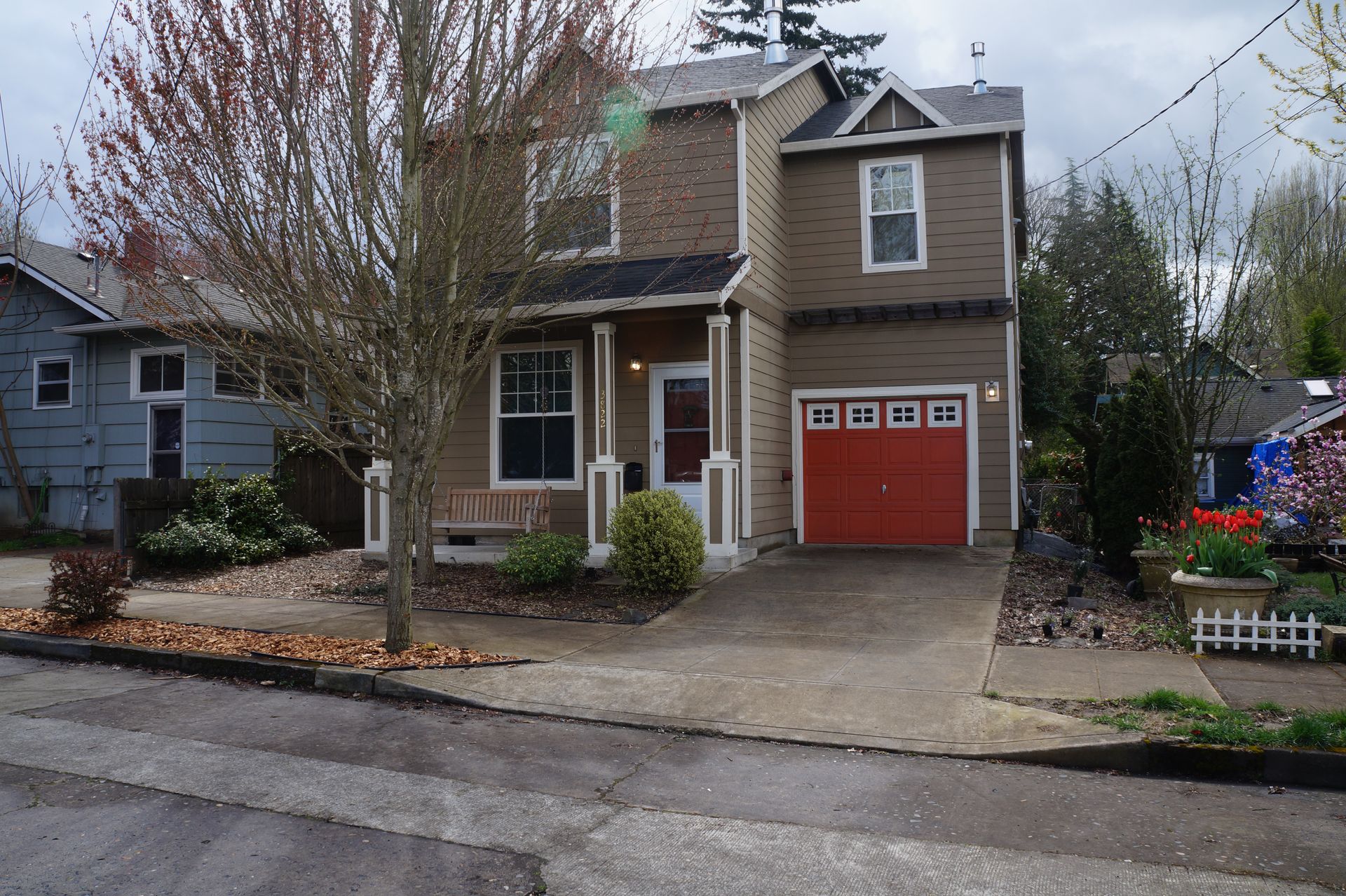 A brown house with a red garage door