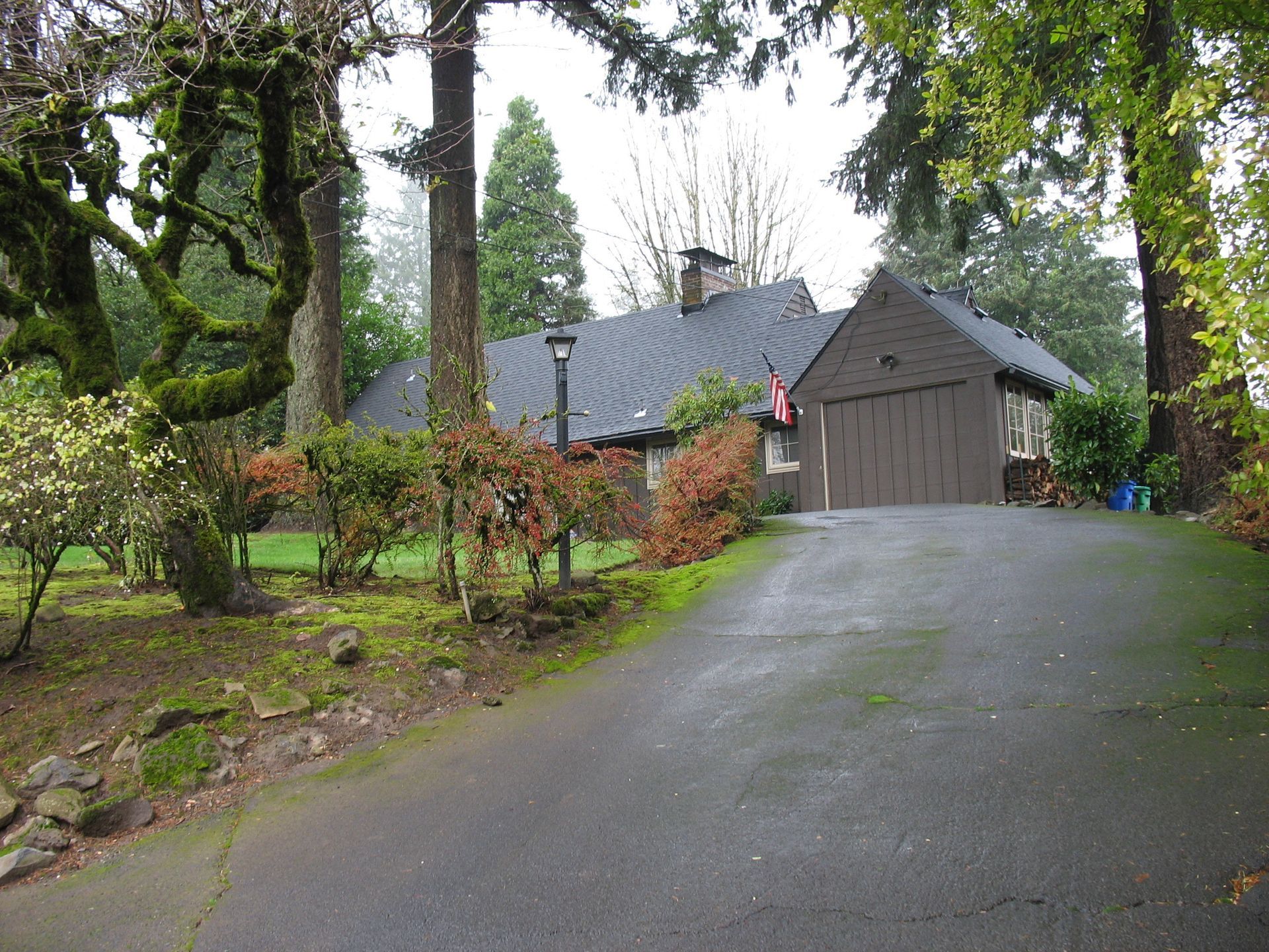 A driveway leading to a house with a garage