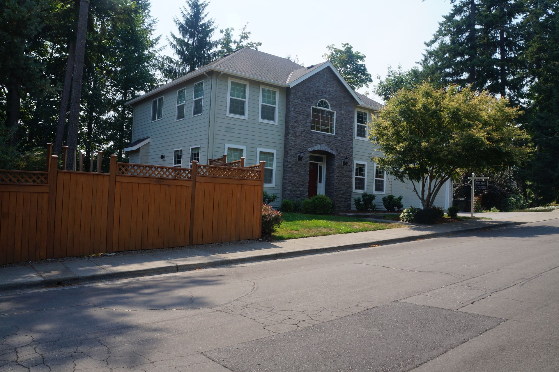 A large house with a wooden fence in front of it