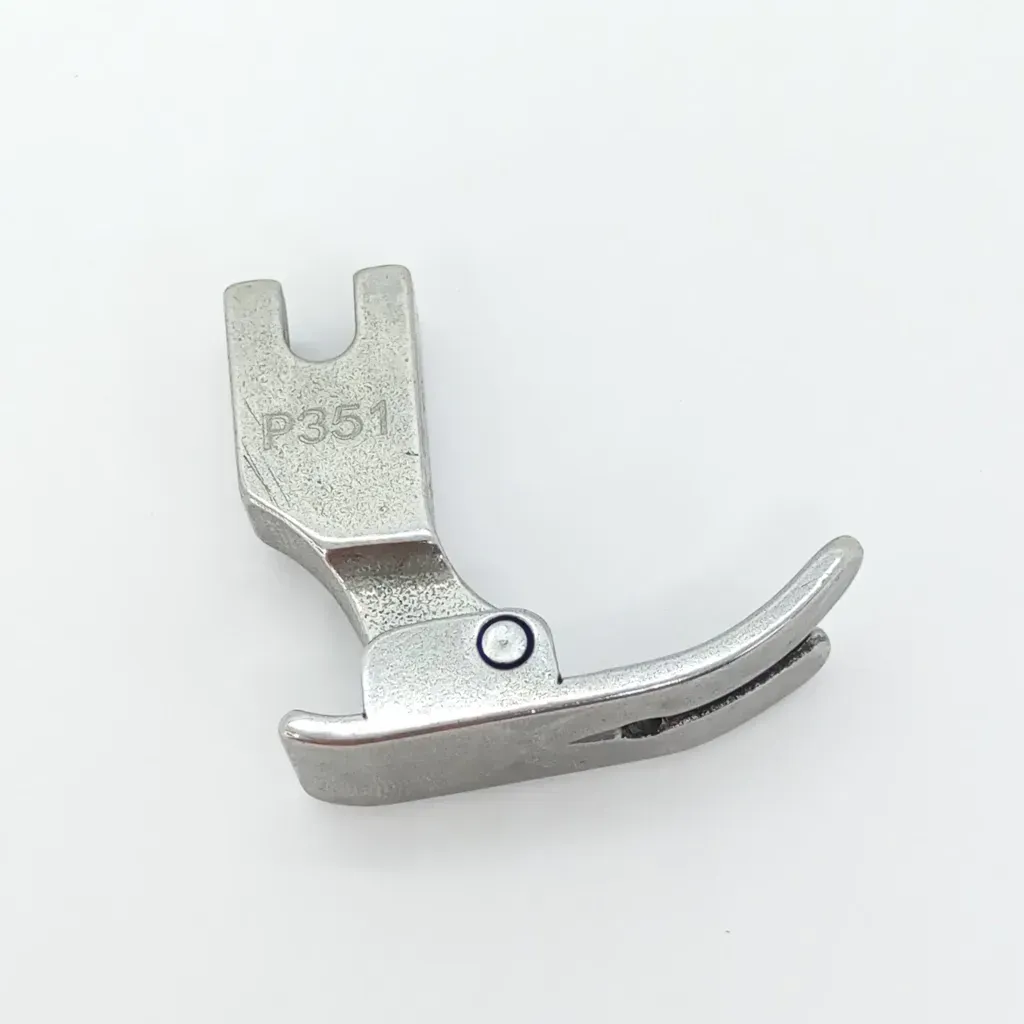 Un prensatelas metálico de color plateado para máquina de coser, con bisagra y dos puntas delanteras, sobre un fondo blanco.