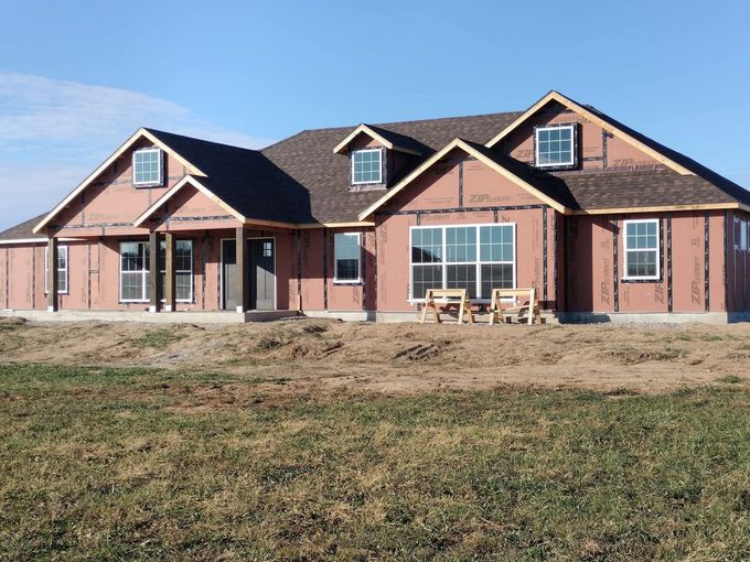 Brick suburban house with a gabled roof and a large front yard Brick suburban house with a gabled roof and a large front yard