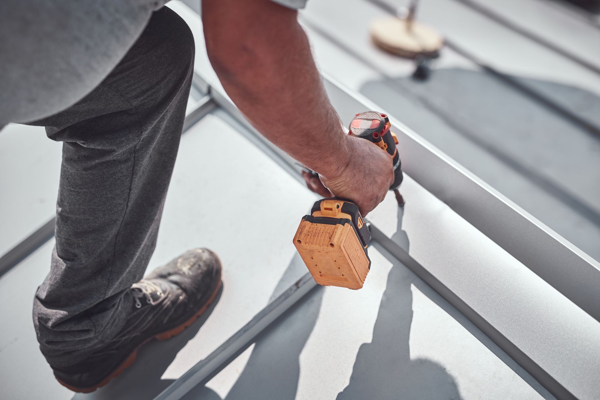 Secure metal roof installation on a house replacement project by a local roofing contractor.
